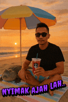 a man sits on a beach with a starbucks drink and a crocodile