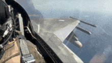 a fighter jet is flying over the ocean with missiles on the wings