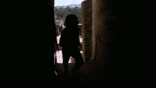 a shadow of a person is cast on a wall in the dark