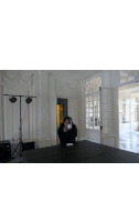 a man standing in a room with a chandelier