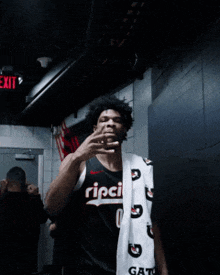 a man wearing a ripci jersey is holding a pair of socks
