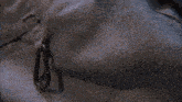 a close up of a piece of cloth with a metal hook on it
