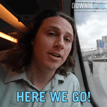 a man on a train with the words here we go