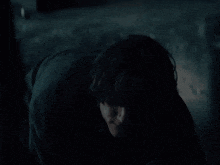 a man in a dark room with a man behind him