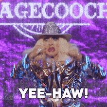 a drag queen in a cowboy hat says yee-haw