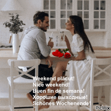 a picture of a man and woman sitting at a table with the caption weekend placut nice weekend buen fin de semana schönes wochenende
