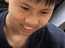 a close up of a young boy 's face with his mouth open
