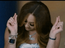 a woman wearing a scotty the body necklace is dancing