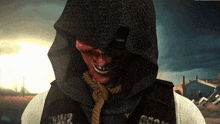 a grim reaper with a rope around his neck and a hood