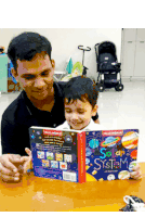a man is reading a book to a young boy titled solar system