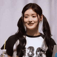 a girl with pigtails and a shirt that says old man sunny