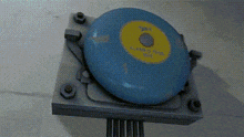 a close up of a blue object with a yellow circle that says " emergency "