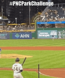 a baseball player with the number 14 on his jersey swings at a pitch