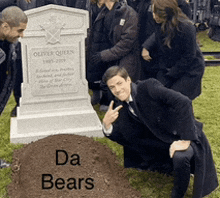 a man kneeling in front of a grave with the words da bears on it