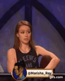 a woman in a black tank top is standing in front of a sign that says sleeves are .