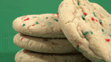 three cookies stacked on top of each other with red and green sprinkles