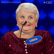 a woman wearing a name tag that says linda
