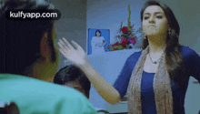 a woman is giving a man a high five in a room .