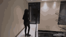 a woman is walking down a hallway with the words made in animotica on the bottom right
