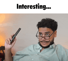 a man with glasses and a mustache is holding a remote control with the words interesting written above him
