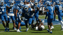 a group of football players wearing blue uniforms that say memphis