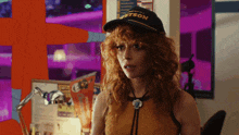 a woman wearing a hat that says " bartson " on it