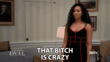 a woman says that bitch is crazy while standing in a living room