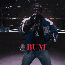 a man is singing into a microphone and the word bum is on the bottom