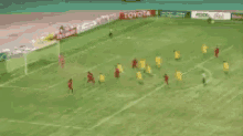 a soccer game is being played on a field with toyota ads on the sidelines