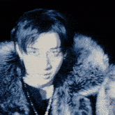 a close up of a person 's face with a fur coat