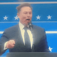 a man in a suit and tie is giving a speech