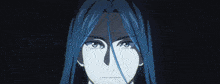 a man with long hair holds a blue ball in his hands