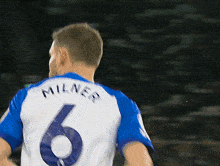 a man in a blue and white jersey with the number 6 on the back