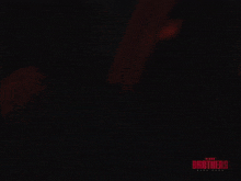 a poster for the movie blood brothers shows a woman in a dark room