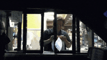 a mcdonald 's drive thru window has a sign on it that says ' no smoking ' on it