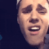 a close up of a man 's face making a funny face .