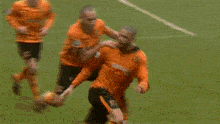 a soccer player wearing an orange jersey with the number 18 on the front