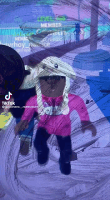 a tiktok video of a girl in a pink jacket and hat
