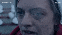 a close up of a woman 's face with the words " the handmaid 's tale " on the bottom