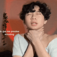 a person with curly hair has their hands around their neck and the words " ts got me preslee emoting " next to them