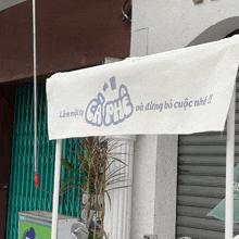 a white canopy with a sign that says " ca phe " on it