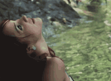 a woman with red hair looks up at something