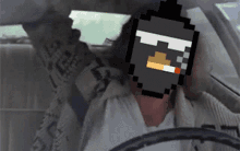 a man in a car with a pixelated face on his face
