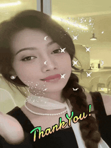 a woman with a pearl necklace says thank you on her face