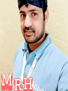 a man wearing a blue shirt with mrh gao written on it
