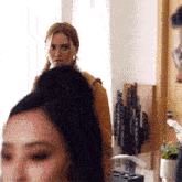 a man and a woman are standing in a room
