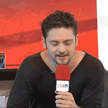 a man holding a microphone that says mix57