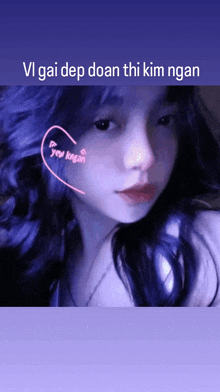 a girl with blue hair has a heart on her cheek that says " yen ngan "