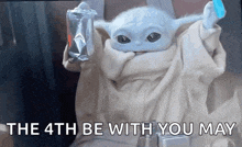 a baby yoda from star wars is holding a bag of food and a blue toothbrush .