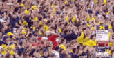 a crowd of people watching a michigan football game on espn
